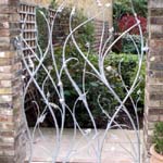 Metal gate made as a plant sculpture