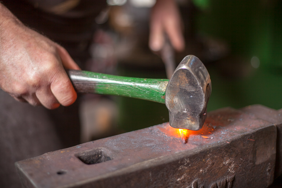 Blacksmith hand forging a taper 