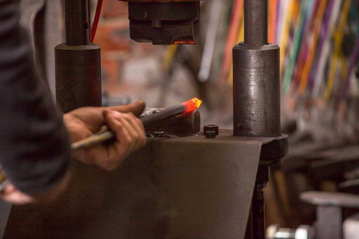 Blacksmith using a power hammer
