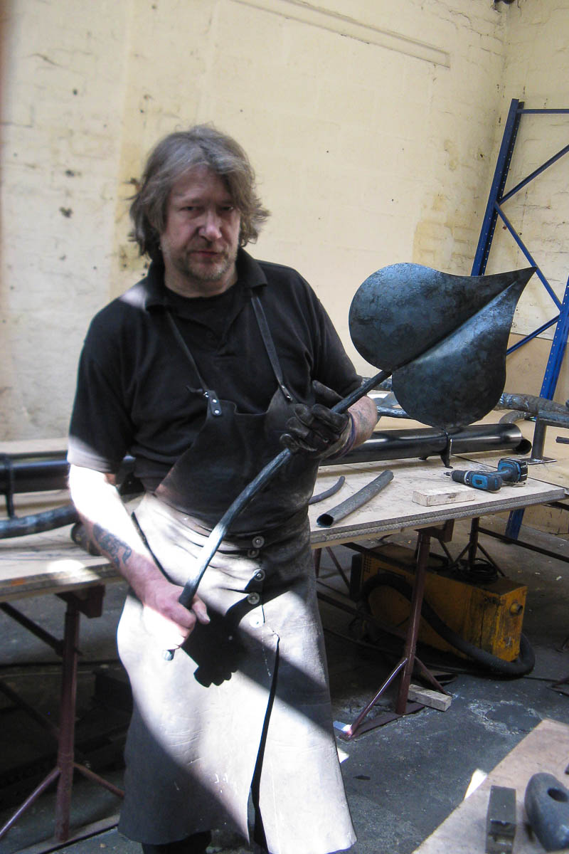David Hyde holding a large hand forged leaf