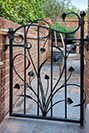 Side gate designed around a stylised plant