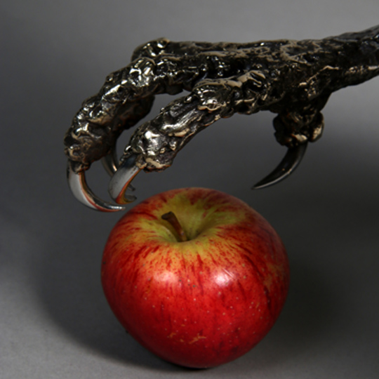 Fire breathing dragon sculpture with an apple for scale