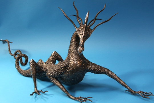 Black metal dragon sculpture