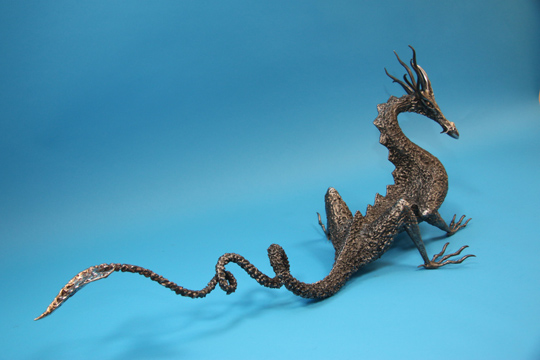 Large welded metal dragon sculpture
