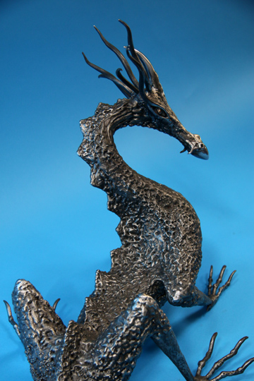 Textured black metal dragon skin sculpture