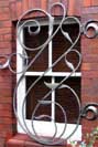 flowing curvilinear wrought iron security grill
