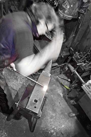 blacksmith working at an anvil