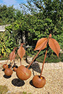 Rusty steel cherries as garden sculpture